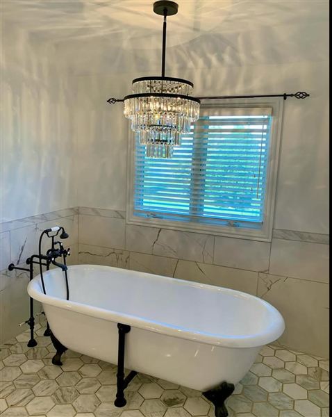 Clawfoot tub wainscoting crystal chandelier