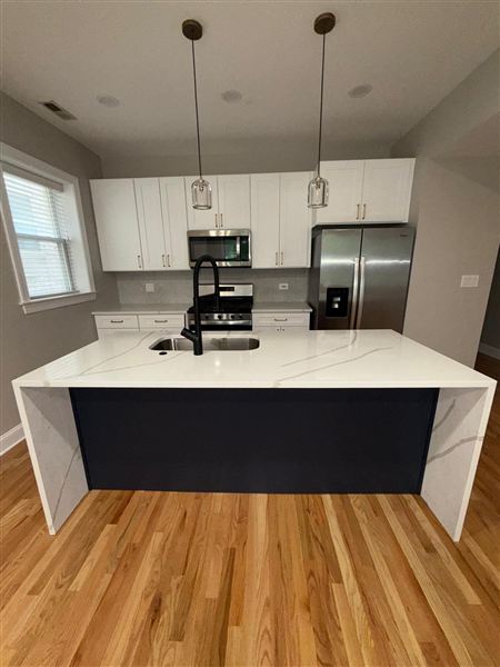 Dark island white quartz waterfall countertop
