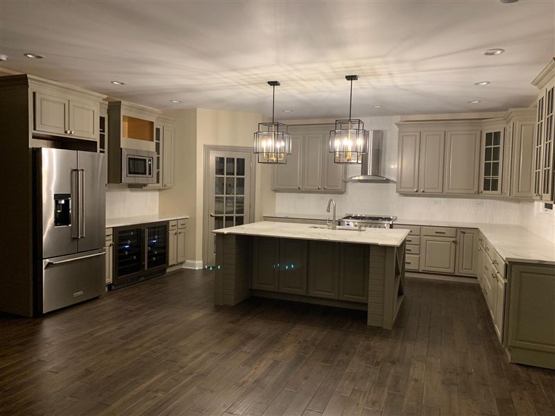Sage green cabinets marble countertops pendant lights