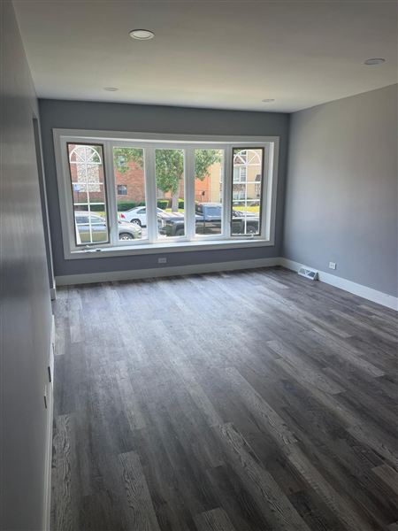 Living room large bow window grey walls